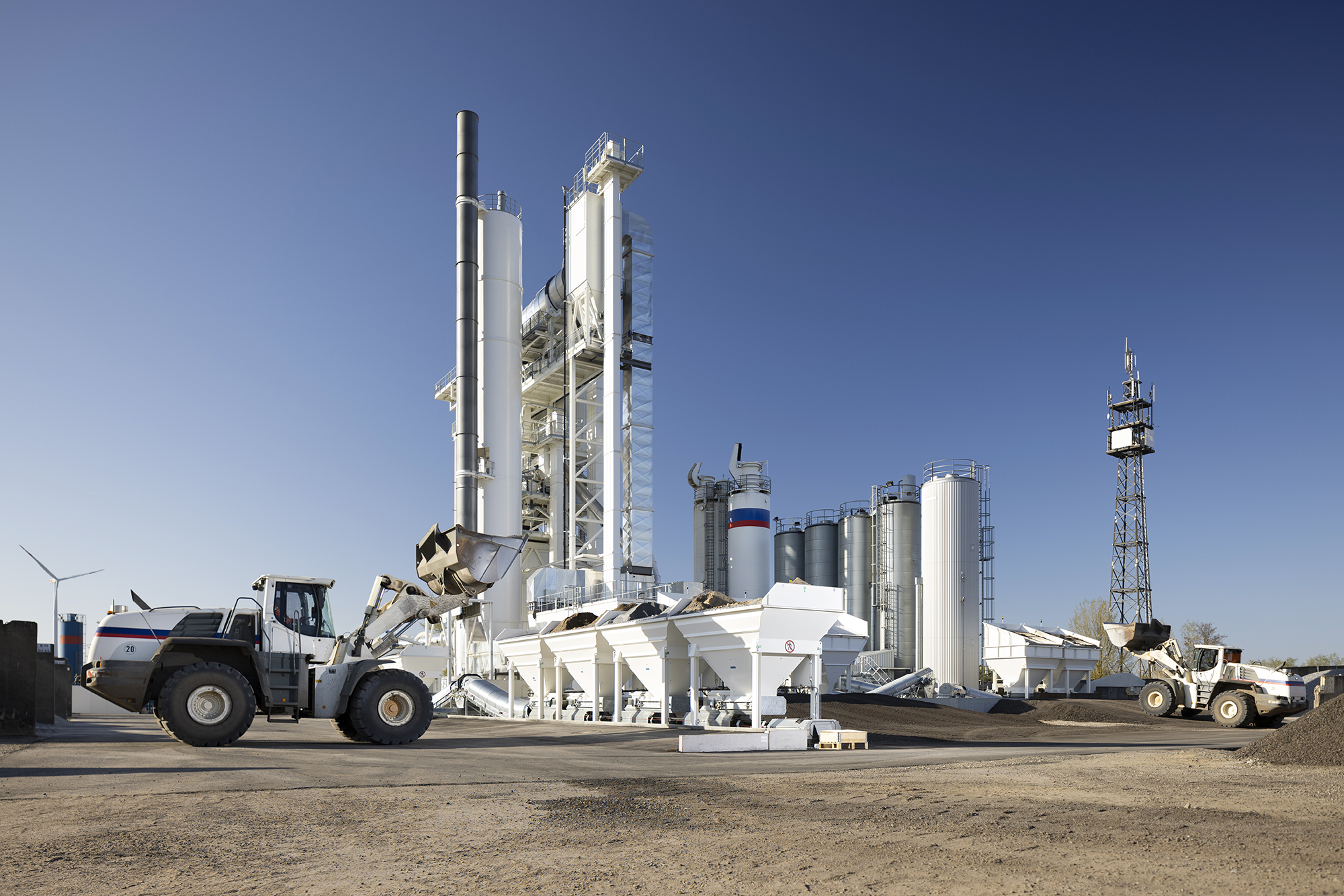 Maschinen und Anlagen eines Asphaltmischwerks bei der Produktion.