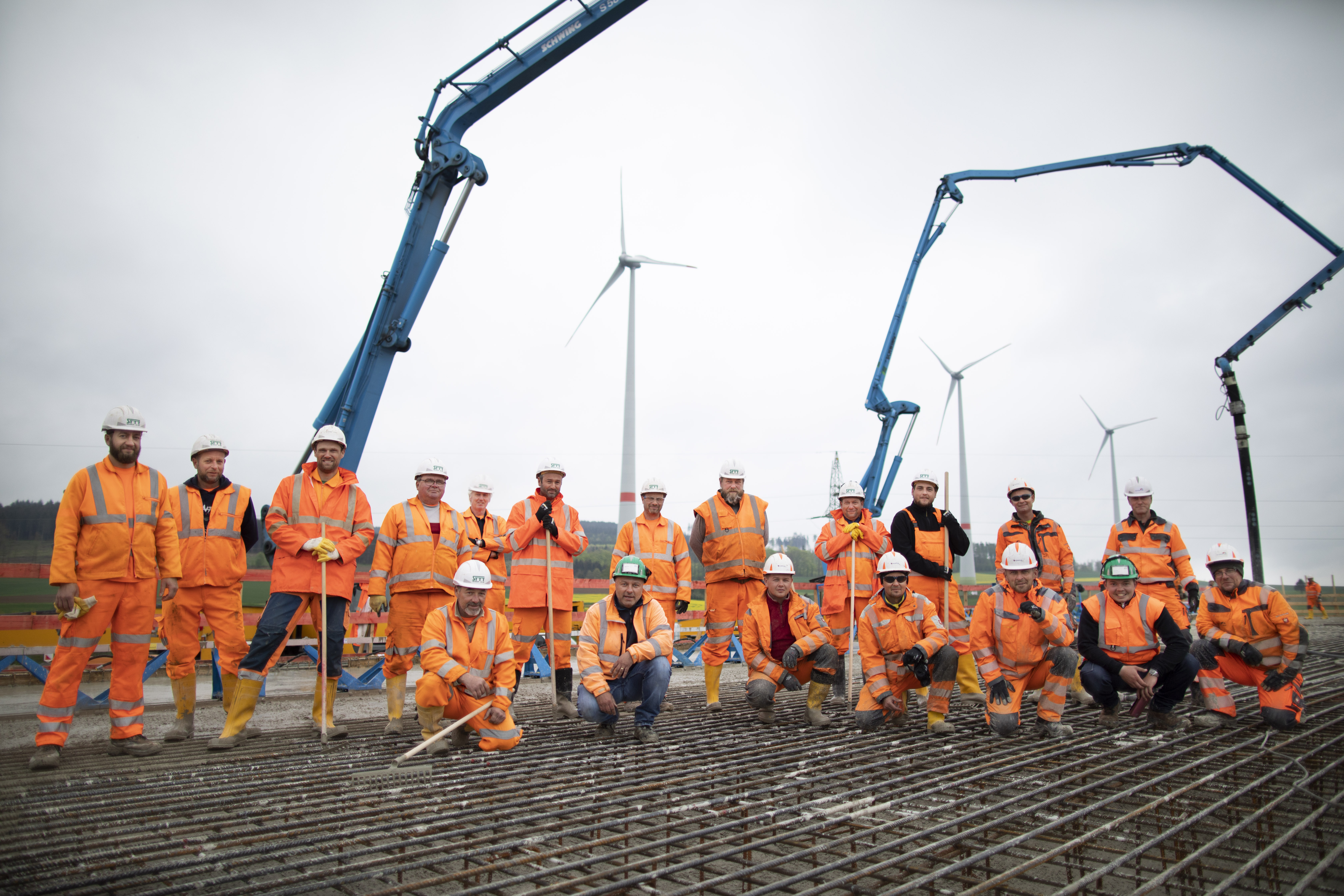 Mitarbeiter, die orangene PSA Kleidung tragen.